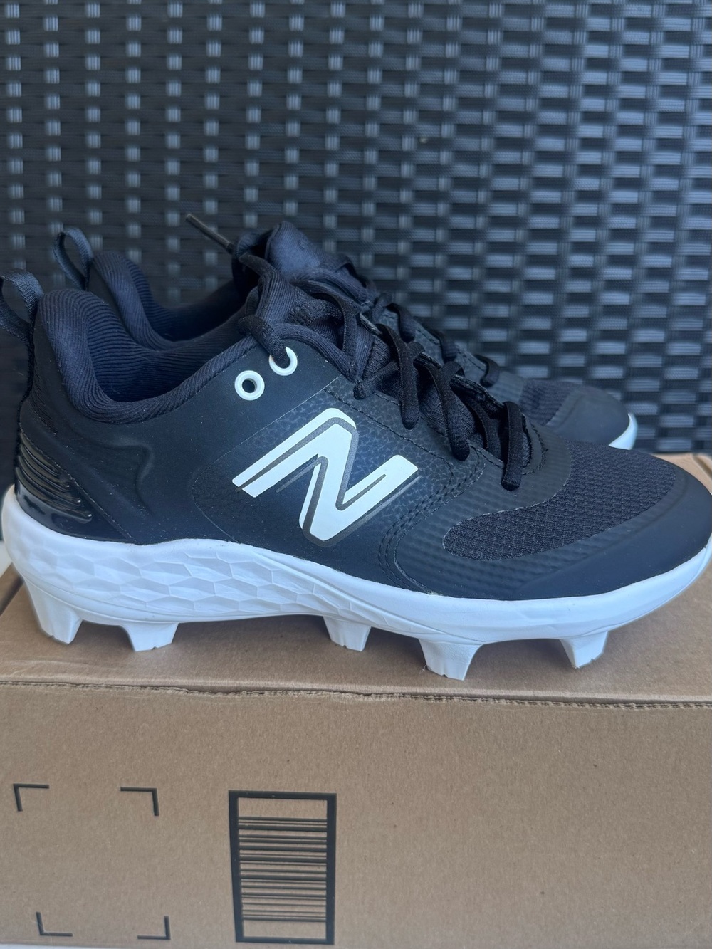 New Balance women’s Black and White Cleats